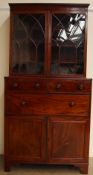 A George III mahogany secretaire bookcase, the moulded cornice above a pair of arched glazed doors,