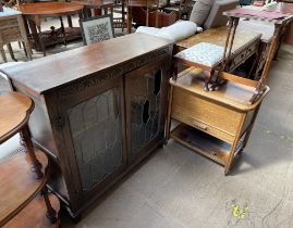 An oak display cabinet, with a pair of leaded glazed doors together with a sewing trolley,