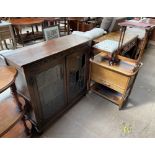 An oak display cabinet, with a pair of leaded glazed doors together with a sewing trolley,