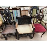 A carved oak X framed elbow chair together with two other carved oak dining chairs,