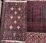 A red ground rug with three rows of stylised guls, and multiple guard stripes,