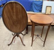 An Edwardian mahogany occasional table of circular form on square tapering legs united by an X