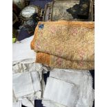 A quilted bed spread together with table linen, trays,