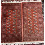 A pair of red ground Turkoman rugs with multiple guls and guard stripes,