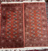 A pair of red ground Turkoman rugs with multiple guls and guard stripes,