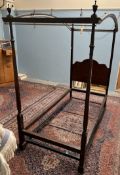 A Heal's of Tottenham Court Road mahogany four poster single bed, with an arched top,