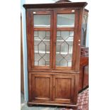 A 19th century mahogany standing corner cupboard with an astragal glazed top and cupboard base