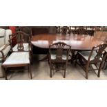 A reproduction mahogany extending dining table and six chairs,