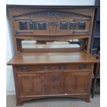 A 20th century oak mirror back sideboard, the raised back with a pair of glazed doors,