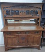 A 20th century oak mirror back sideboard, the raised back with a pair of glazed doors,