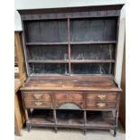 An 18th century South Wales oak dresser, the rack with a moulded cornice and three shelves,