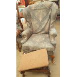 An upholstered wingback armchair on cabriole legs together with a foot stool
