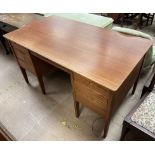 A mid 20th century teak desk with a rectangular top above two banks of drawers on square tapering