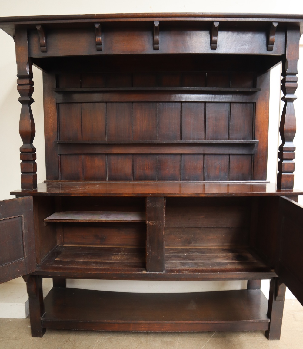 An early 20th century oak dresser with a moulded cornice above a plate rack,