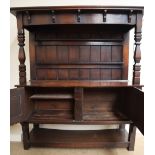 An early 20th century oak dresser with a moulded cornice above a plate rack,