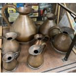 A set of seven French copper measuring jugs
