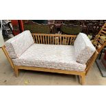 A Beech bed settee / day bed on splayed legs,
