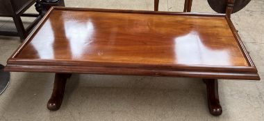 A mukwa wood coffee table of rectangular form on columns and splayed legs 150cm long