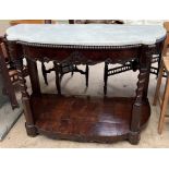 A 19th century mahogany and marble topped console table with a shaped top above a carved shallow
