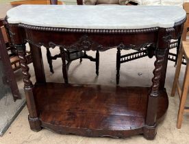 A 19th century mahogany and marble topped console table with a shaped top above a carved shallow