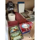 A tin plate oil lamp together with a collection of postcards,