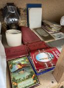 A tin plate oil lamp together with a collection of postcards,