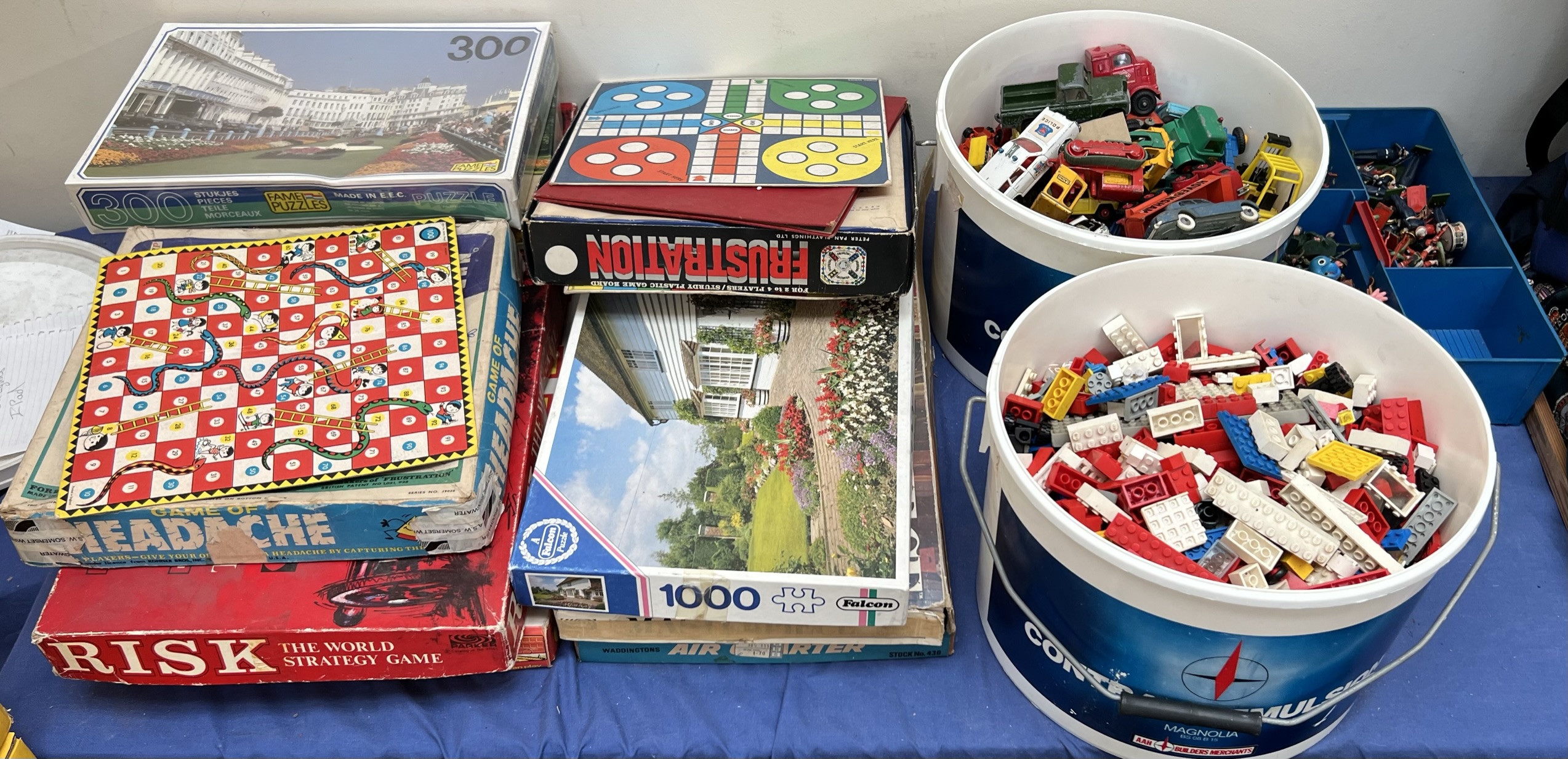 Assorted board games together with lego, model cars,