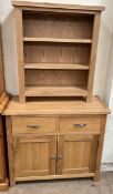 A 20th century oak side cabinet with two drawers and two cupboards on square legs together with a