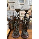 A pair of spelter table lamps in the form of maidens with festooned pillars on circular base