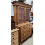 A 19th century oak bookcase with a moulded cornice above a pair of glazed doors,