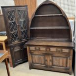 An oak dresser with a pointed arched rack above a two drawer base together with a standing corner