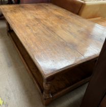 A 20th century oak coffee table of planked rectangular form on turned legs united by an undertier,