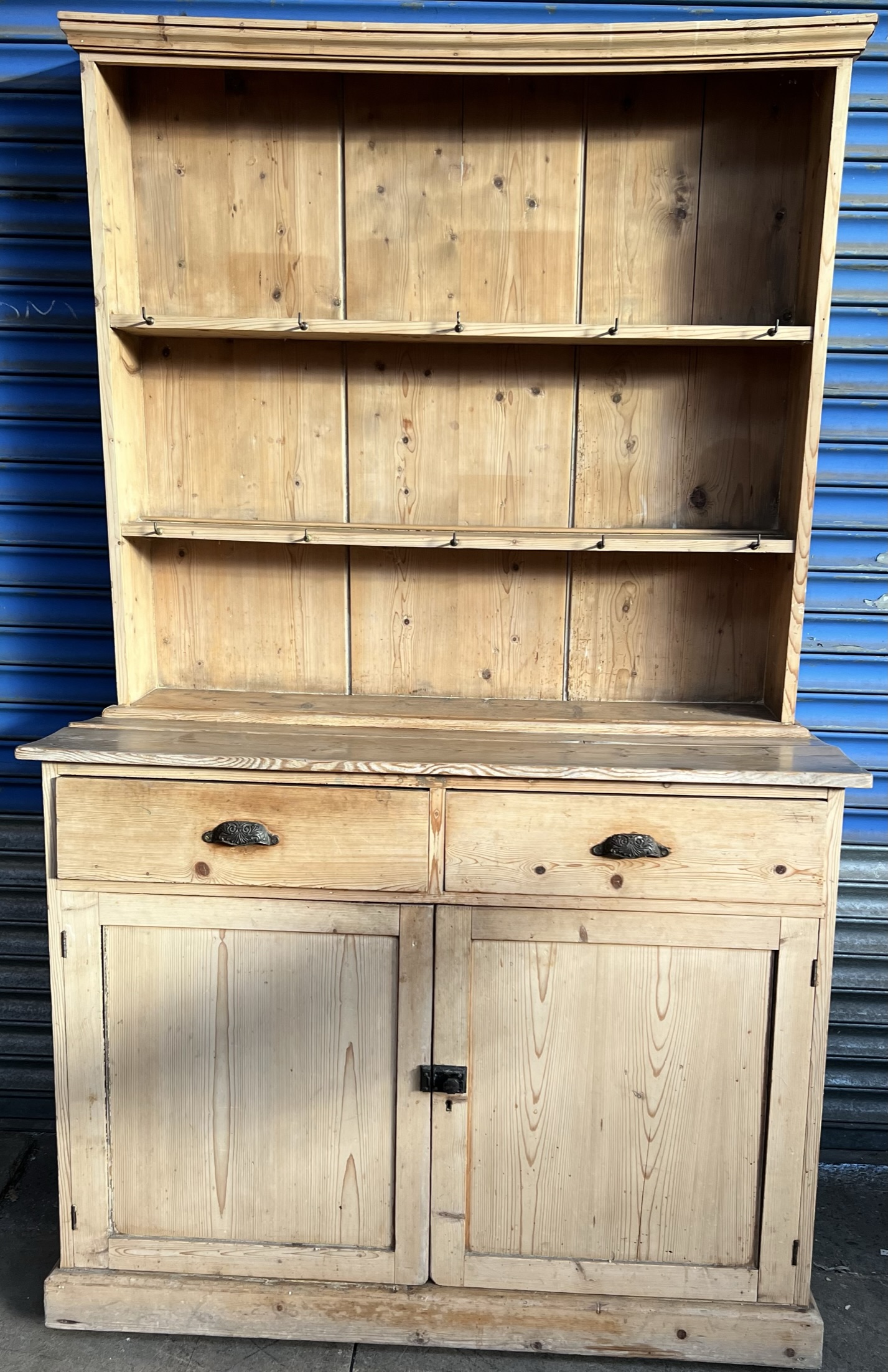 A Victorian pine dresser, with a moulded cornice above two shelves,