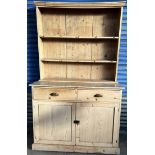 A Victorian pine dresser, with a moulded cornice above two shelves,