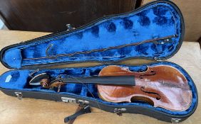 A violin, with a two piece back and ebonised stringing, bears a label for "Antonius Stradivarius,