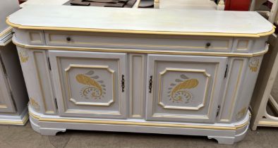 A modern cream and yellow painted side cabinet with three drawers and two cupboards on bracket feet