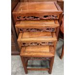 A Chinese hardwood quartetto nest of tables of rectangular form with carved pierced aprons