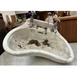A shaped porcelain sink,