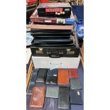 A collection of document folders, briefcases,