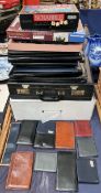 A collection of document folders, briefcases,