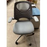 An office chair with adjustable arms and seat on casters