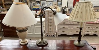 A brass table lamp of arched form with a conical glass lamp shade together with two other table