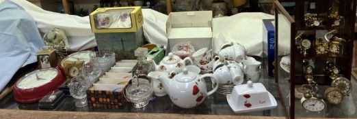 A display cabinet together with a collection of miniature timepieces together with part tea sets,