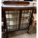 A 20th century mahogany display cabinet with glazed doors and sides on cabriole legs and claw and