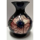 A Moorcroft pottery flared baluster vase decorated in the anemone pattern, impressed marks,