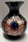 A Moorcroft pottery flared baluster vase decorated in the anemone pattern, impressed marks,