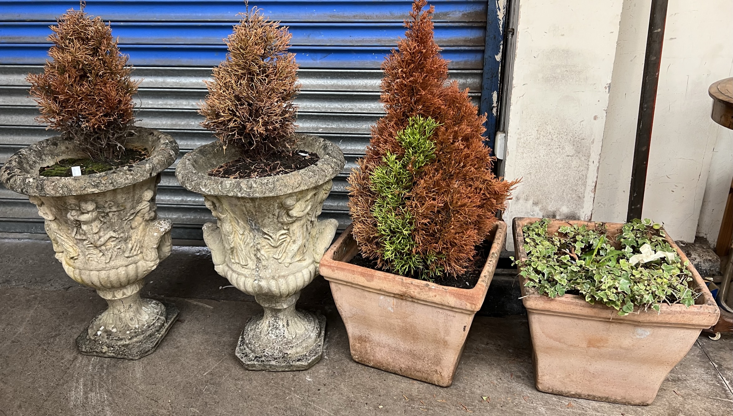 A pair of reconstituted stone garden urn planters together with two square terracotta pots