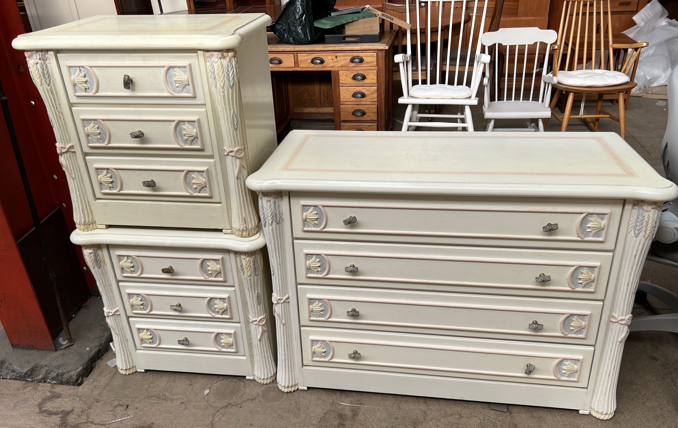 A modern cream painted four drawer chest decorated with tied wheat sheaves together with a pair of