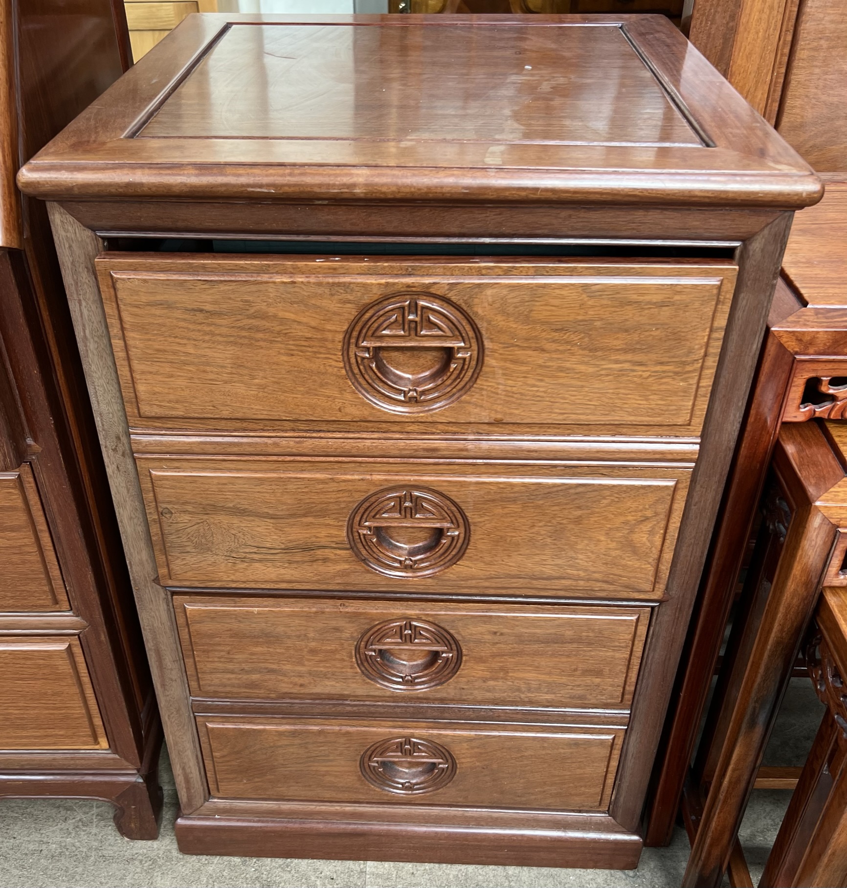 A Chinese hardwood filing cabinet with a square top above two deep drawers with faux drawer fronts