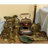 A pair of brass horse door stops together with various brass candlesticks, brass lamps,